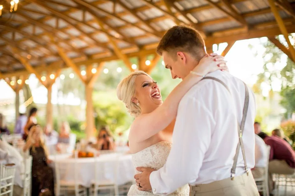 Bride and groom laugh during their first dance