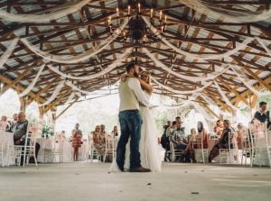 Couple dances in rustic open air barn.