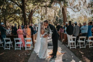 Bride and groom kissing after their ceremony at All4One Farms.