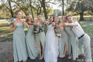 The bridesmaid admire the wedding ring on the brides finger at All4One Farms wedding venue.