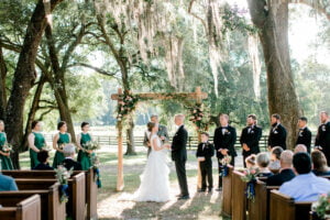 Bride and groom face each other at the alter during their ceremony at All4One Farms wedding venue.