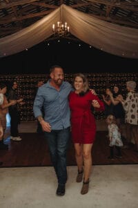 Couple enjoying a reception at All4One Farms showing off their fall fashion choices.