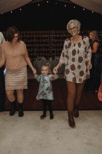 Three generations of wedding guests enjoy a fall reception at All4One Farms in Jacksonville, FL.