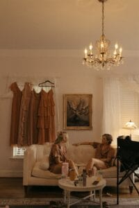 Bridesmaids enjoy a quiet moments before getting into their dresses, in the bridal suite at All4One Farms wedding venue.