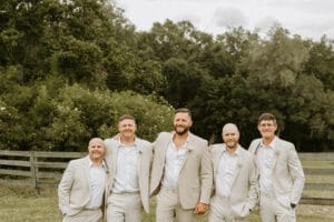 The groom and his groomsmen on the back lawn at All4One Farms waiting for the ceremony to start.