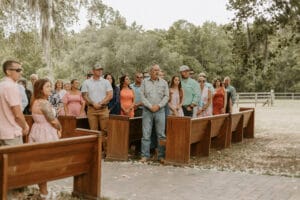 Wedding guests standing for the entrance of the bride at All4One Farms in Jacksonville, FL.