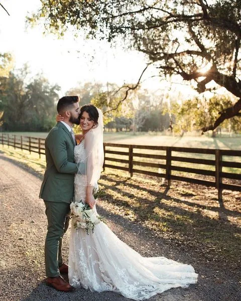 Groom kisses Bride on the cheek at sunset at All4One Farms.