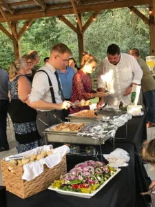 Wedding guests serving their plates at a buffet.