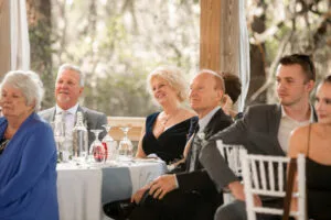 Wedding guests seated at a round table at a wedding reception.