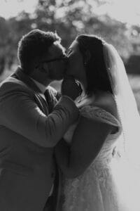 Groom kissing bride in silhouette at All4one Farms