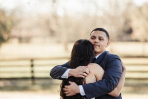 Newly engaged couple embrace at All4One Farms.