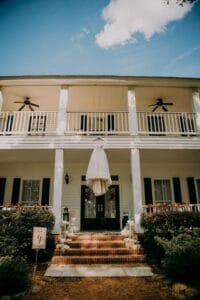 Wedding gown hung from porch roof at All4One Farms.