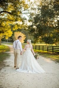 Bride and groom walking down the lane at All4One Farms.