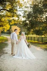 Bride and groom walking down the lane at Jax wedding venue.