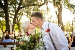 Bride and groom kiss after being declared husband and wife at Jax wedding venue.