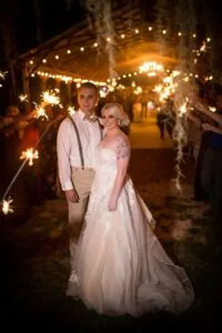 Bride and groom in front of sparkler line up at Jax wedding venue.