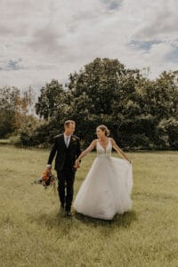 Bride and groom in pasture at Jax wedding venue