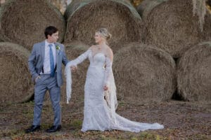 Bride and Groom in front of hay bales at Jax wedding venue.